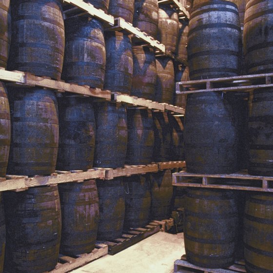 Whiskey is aged in large wooden barrels.