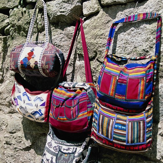 Peruvian traditional dress uses brightly colored fabrics, as evidenced in these handbags.
