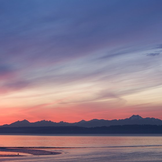 The sun sets over the Olympic Mountains, a backdrop to an RV camping adventure.