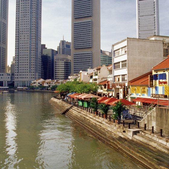 The Singapore River, lined with office buildings, apartments, shops and restaurants, runs through the heart of the city.
