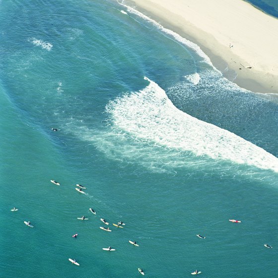 Surfers enjoy Malibu's blue waters, particularly during the winter and summer swells.