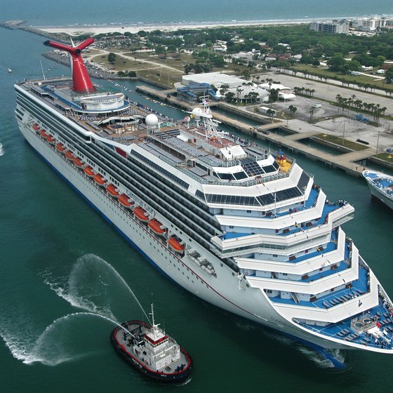 A Carnival Cruise ship receives a tugboat escort in the Port of Miami.