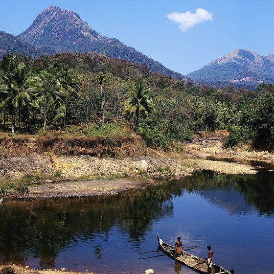 Native canoes share the waterways as you kayak through Kerala