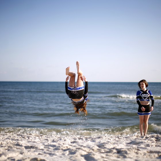 Visitors enjoy back flips on Pensacola Beach.