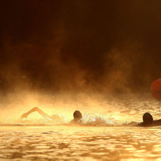 Athletes swim in the Russian River during a triathlon.