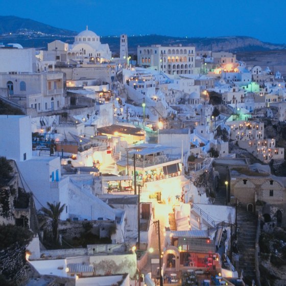 Santorini beckons travelers with its dramatic twilight cityscape.