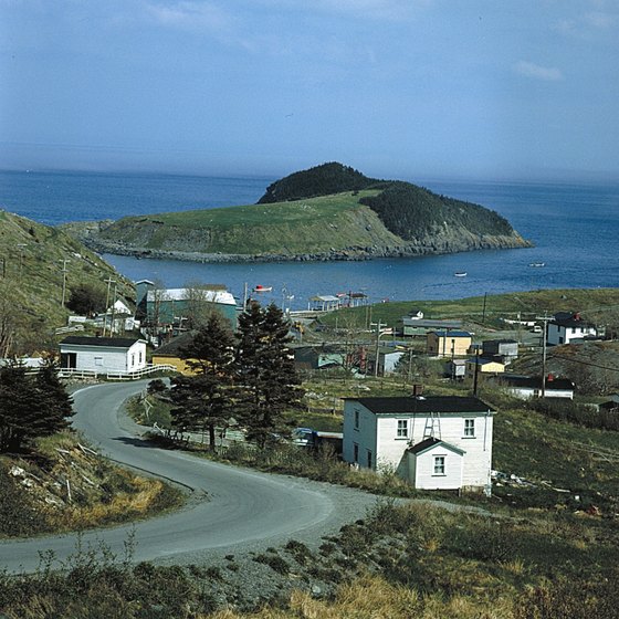 Fishing villages line the shore of Newfoundland; pronunciation of the province is subject to debate.