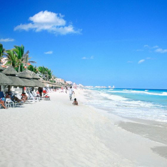 Let your baby explore Cancun's sandy beaches in a shaded area.