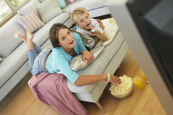 Flying Colours Ltd/Digital Vision/Getty Images Brother (7-9) and sister (14-16) watching television