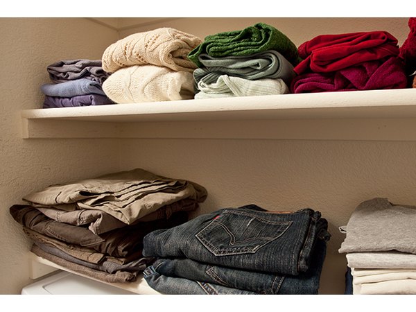 Stack clothing items and organize them by color on your new shelves.