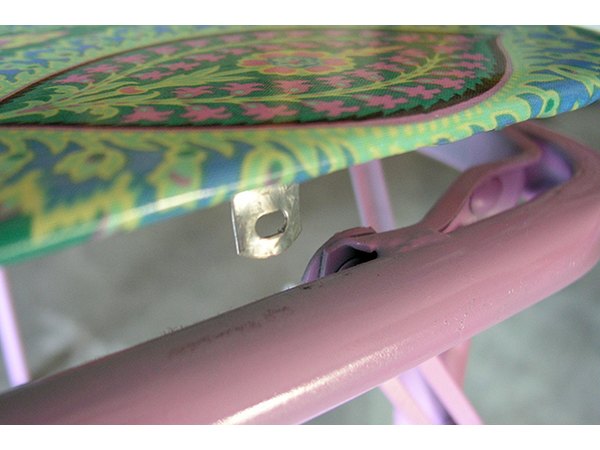 Carefully press table top into frame and screw in place.