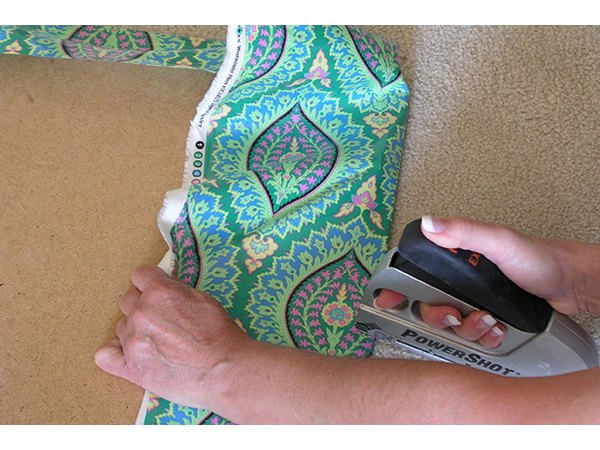 Tack the fabric in place on each of the four sides.