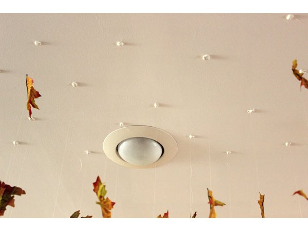 Press the poster putty to the ceiling