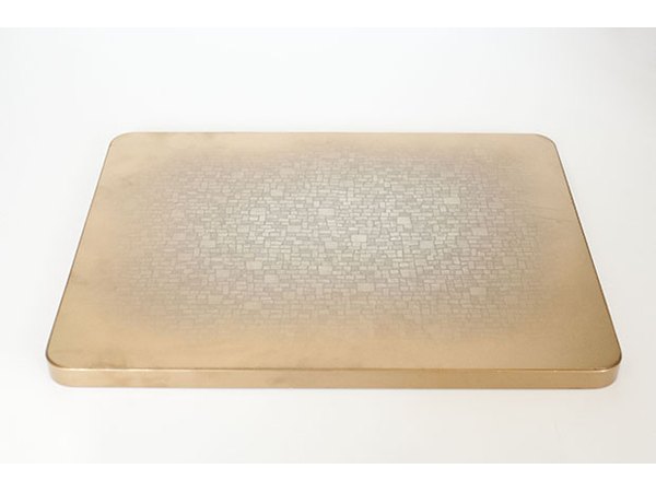Gold spray paint adds new metallic shine to the edges of the tabletop.