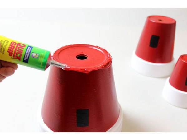 Apply adhesive to the base of the large pot