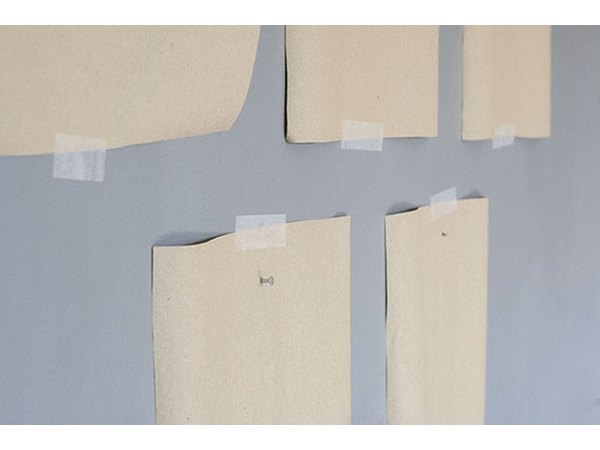 Add picture hanging nails right through the kraft paper.