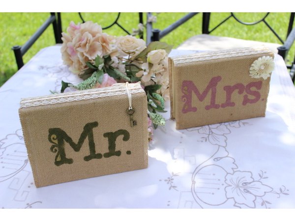 Mr. and Mrs. books wrapped in burlap as sweethearts table centerpiece.