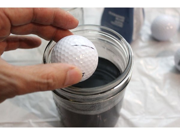 Drop the golf ball in the jar