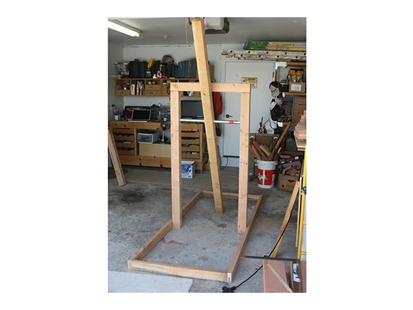 Assembled structure with pipe threaded through 4x4s.