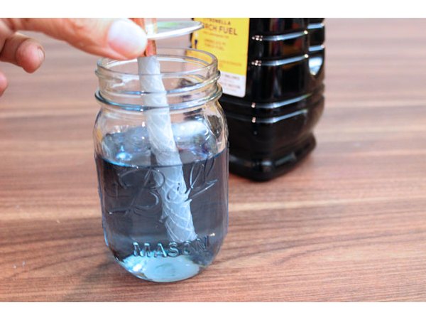 Fill the jar with torch fuel