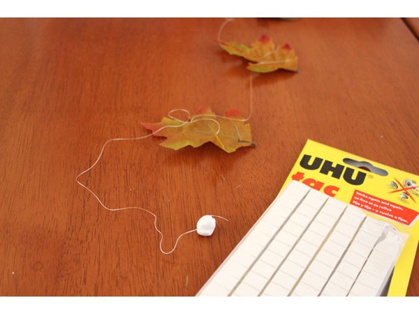 Attach poster putty to the end of the thread
