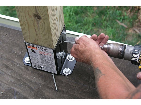A hammer drill speeds the bolt installation.