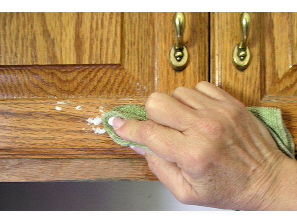 Baking soda will not scratch the cabinets.