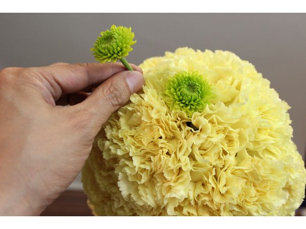 Make polka dots with pom poms