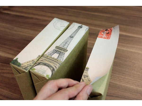 Adhere the cut-up images to the boxes