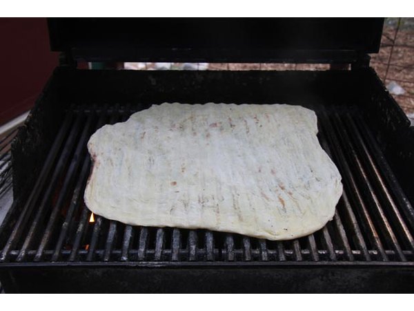 Lightly cook one side of the dough.