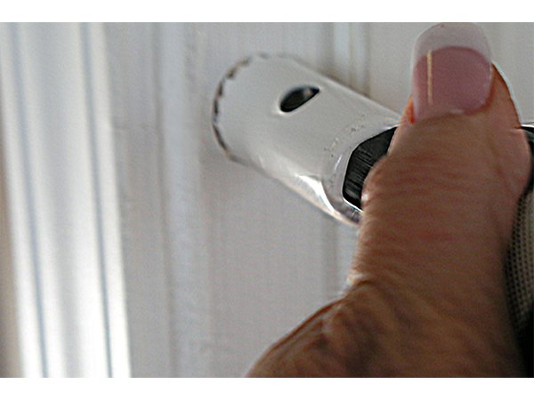 Use a chisel to knock out the wood plug if using a hole saw.