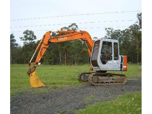 Use a small excavator like this one to begin tearing up the asphalt surface.