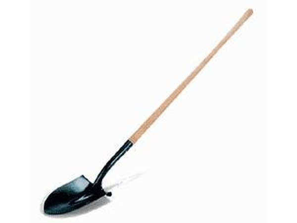Use a pick ax and shovel in areas close to a building.