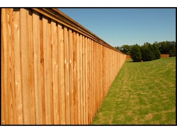 This cedar stockade style fence has a clear sealant applied to preserve the color of the wood.
