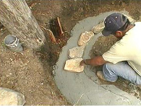 Place river rocks in the mortar.
