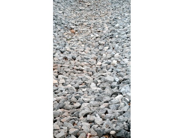 Gravel is inexpensive and easy to spread in driveway areas that need resurfacing.