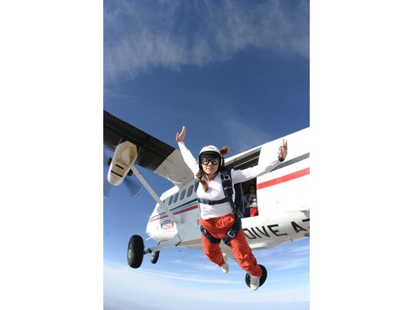 Skydivers freefall and then open a parachute to float back to land.