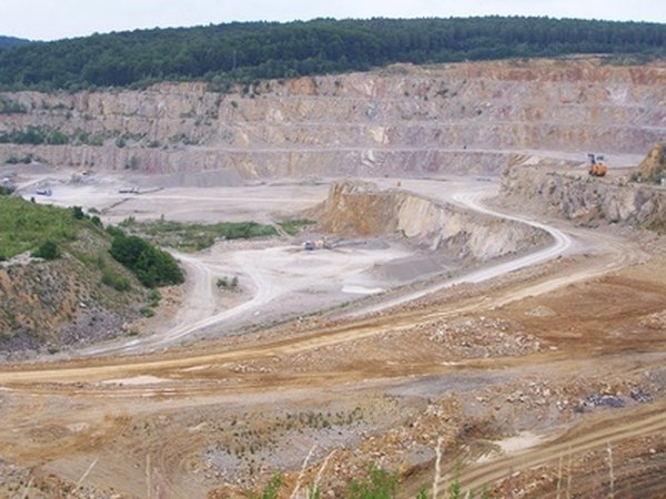Limestone deposits are mined from quarries often covering thousands of acres.