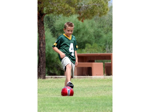 Show a young player how to stop the soccer ball with one foot.