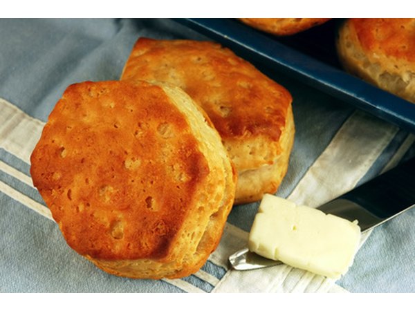 Top buttermilk biscuits with white cream gravy for a Southern brunch treat.