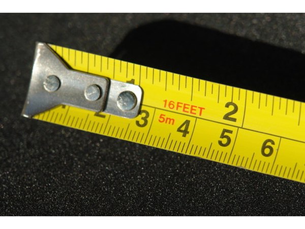 Measuring tape is used to obtain correct dimensions for the tooth costume.
