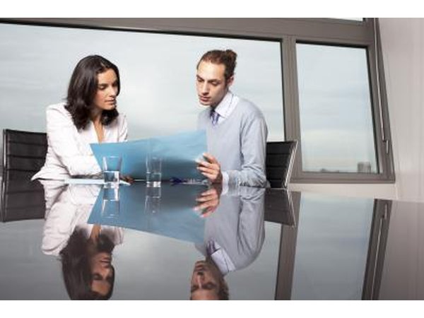 bank manager looking at finances with employee