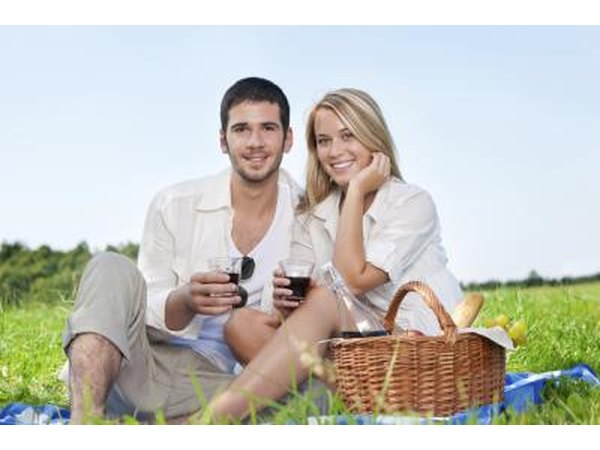 Couple with wine on romantic picnic
