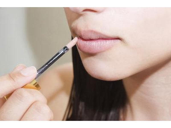 Teen applying lip gloss