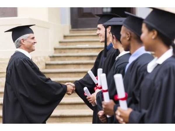 Dean shaking hands with students