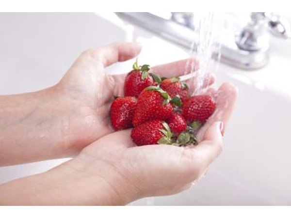 Woman washing strawberries