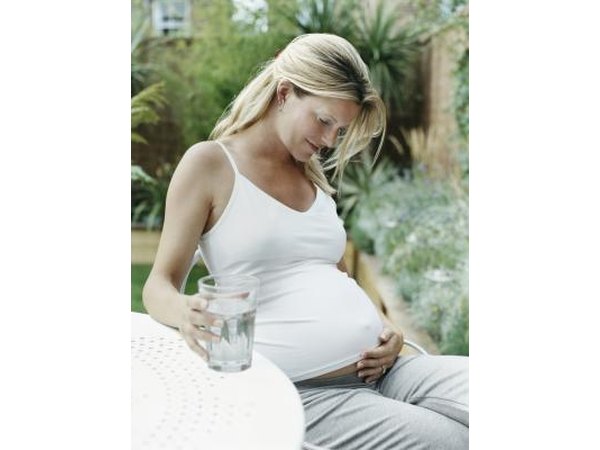 Pregnant woman resting and drinking water