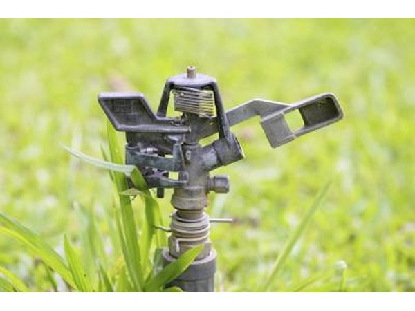 Close-up of stopped sprinkler on grass