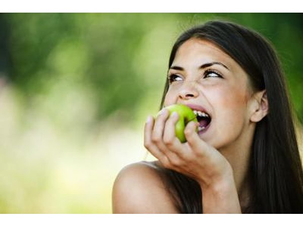 girl biting into apple
