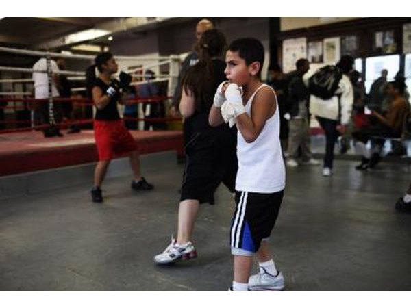 Boy practicing boxing in community gym